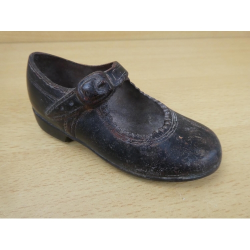 85 - An antique cast metal child's shoe.