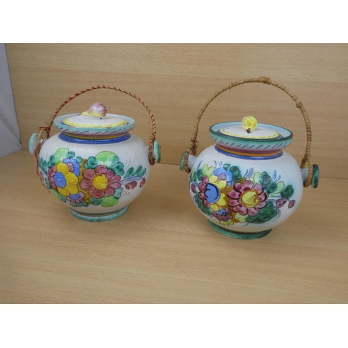 115 - A pair of Italian pottery lidded urns.