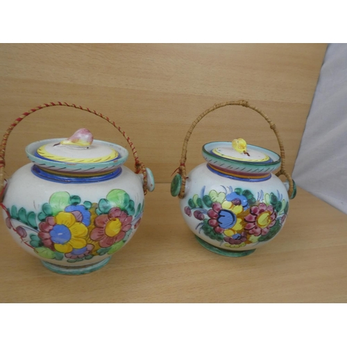 115 - A pair of Italian pottery lidded urns.