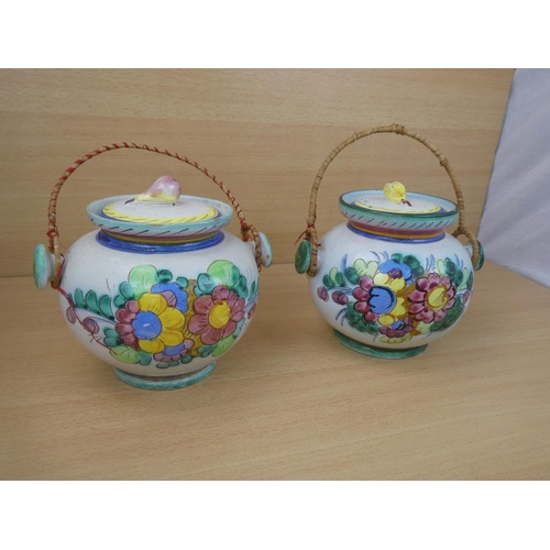 115 - A pair of Italian pottery lidded urns.