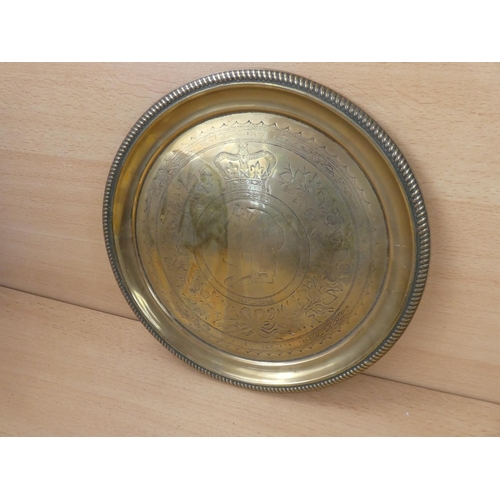 124 - An antique commemorative brass charger.