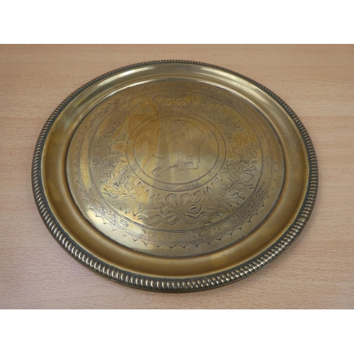 124 - An antique commemorative brass charger.