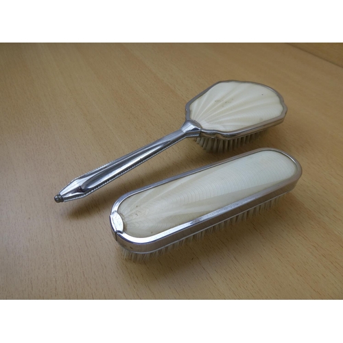 143 - Two vintage dressing table brushes.