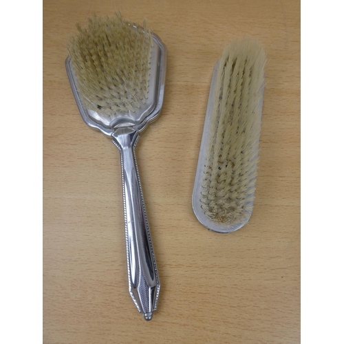 143 - Two vintage dressing table brushes.