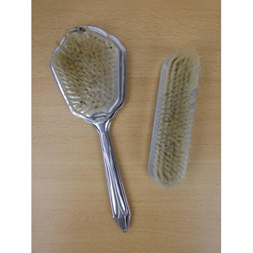 143 - Two vintage dressing table brushes.