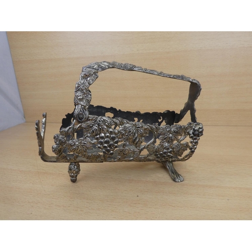 145 - A metal wine holder decorated with grapes.