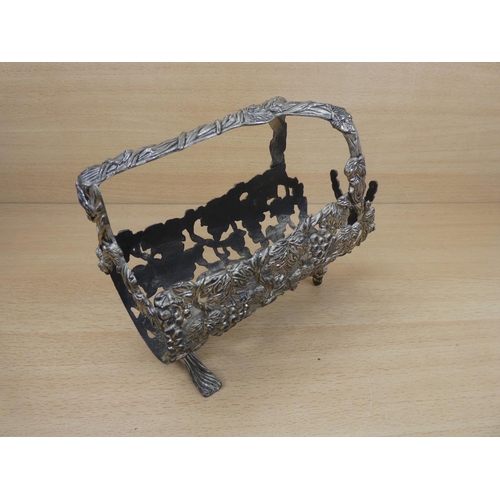 145 - A metal wine holder decorated with grapes.