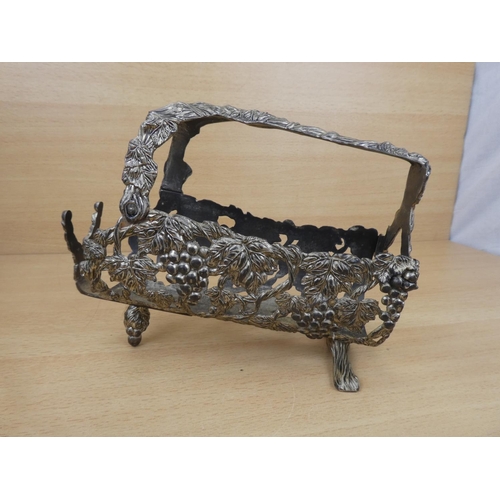 145 - A metal wine holder decorated with grapes.