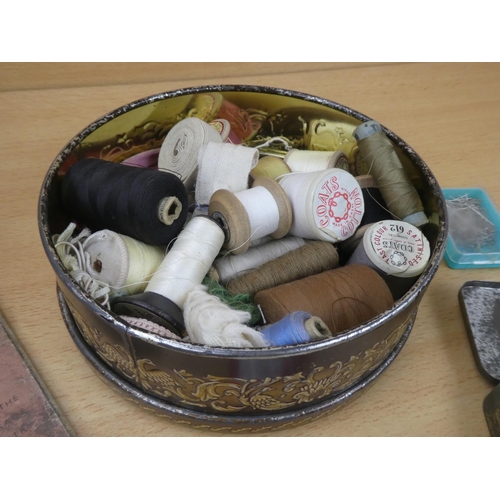 152 - A vintage tin and a lot of sewing thread and a Make Do and Mend booklet.