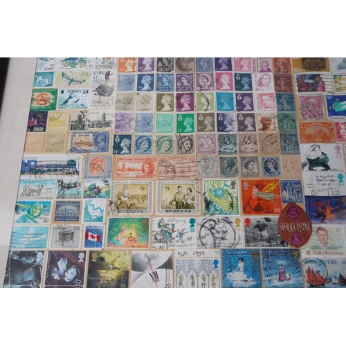 209 - A framed display of used postage stamps, measuring 42x53cm.