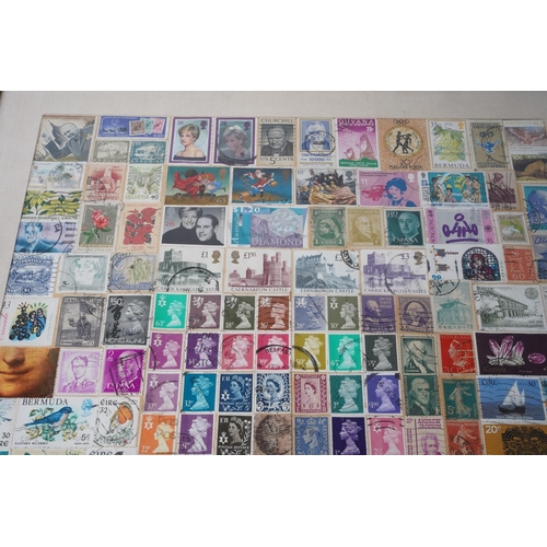 209 - A framed display of used postage stamps, measuring 42x53cm.