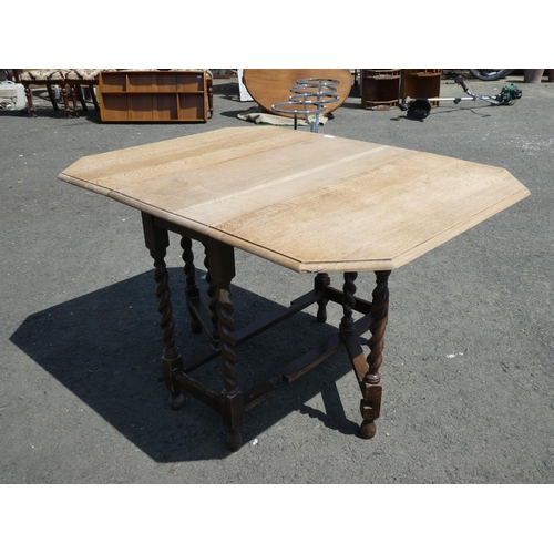 221 - A vintage oak dropleaf dining table with barley twist legs.