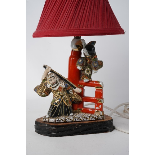 241 - A vintage Oriental based table lamp and shade, measuring 37cm in height.