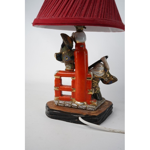 241 - A vintage Oriental based table lamp and shade, measuring 37cm in height.