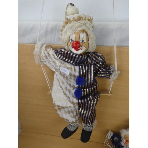 308 - Two porcelain faced clowns.