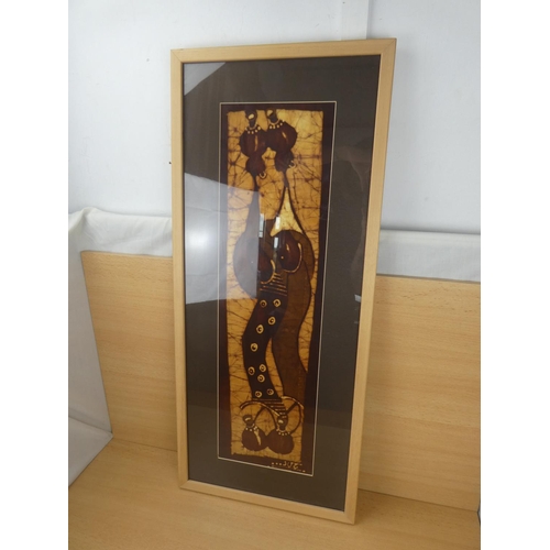 316 - A framed fabric panel of African figures, measuring 39x90cm.