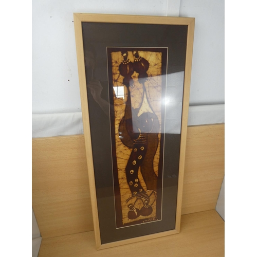 316 - A framed fabric panel of African figures, measuring 39x90cm.