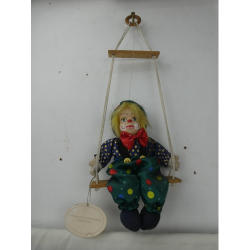 319 - A porcelain faced clown.