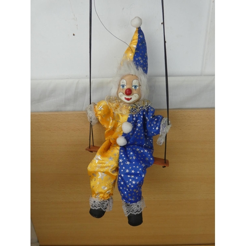 324 - A porcelain faced clown,