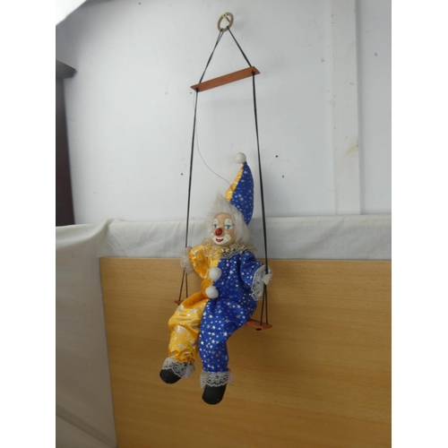 324 - A porcelain faced clown,