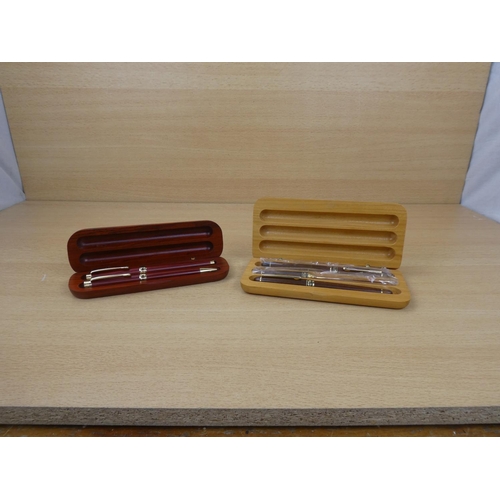 395 - Two wooden cased set of collectors pens.