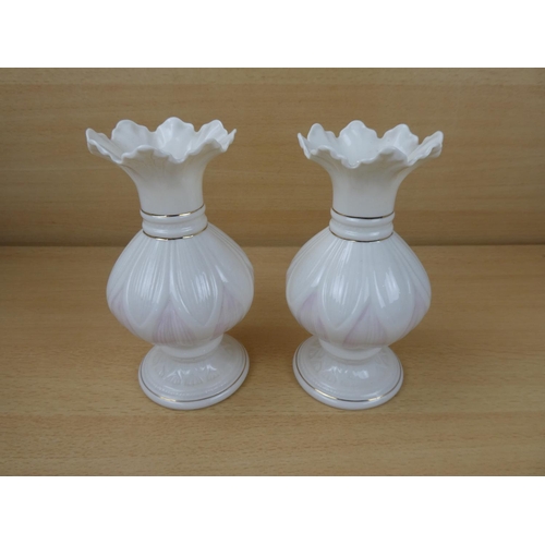 420 - A pair of Belleek pottery vases.