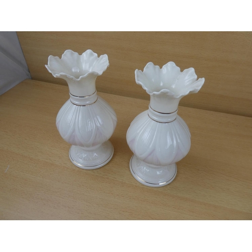 420 - A pair of Belleek pottery vases.