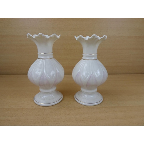 420 - A pair of Belleek pottery vases.