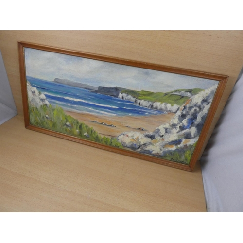 495 - A framed oil on board 'North Antrim Coastline', measuring 73x36cm.