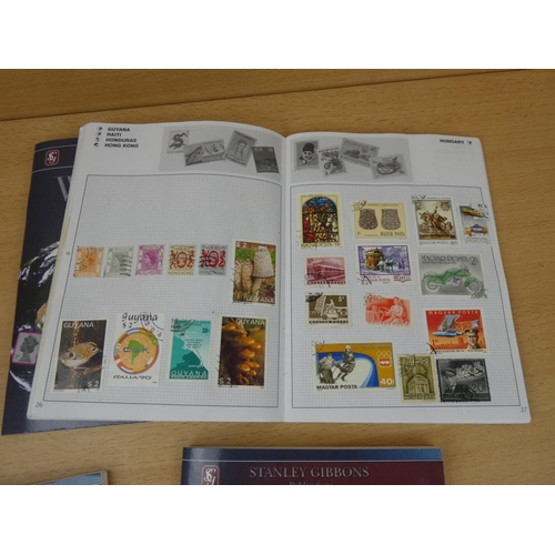 543 - A set of five Stanley Gibbons 'World' stamp albums and contents.