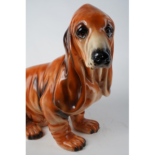 656 - A large ceramic Basset Hound/ dog, measuring 44cm in height. (a/f)