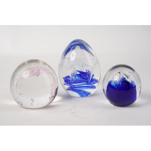 672 - Three colourful glass paperweights.