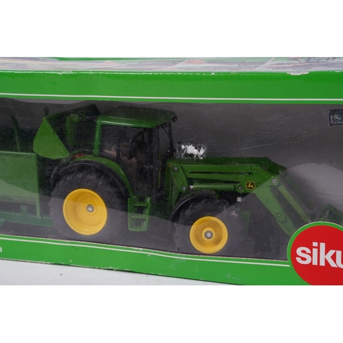 726 - A boxed Siku metal 336524 John Deere with Front Loader and trailer set, scale 1:32