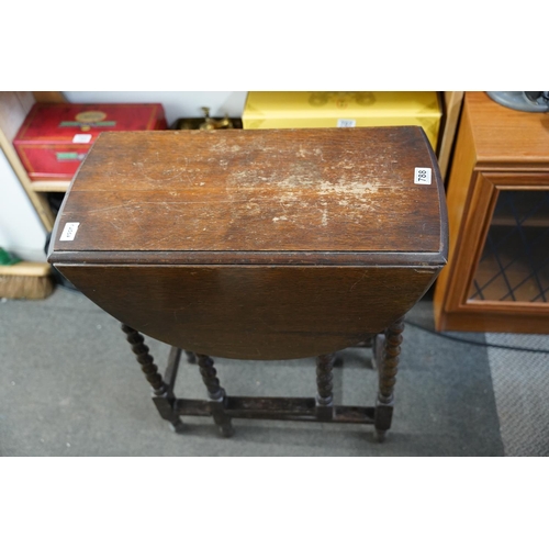 788 - A small oak dropleaf table with barley twist legs.