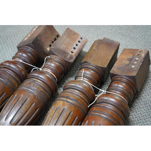 811 - A set of four antique mahogany table legs on casters.