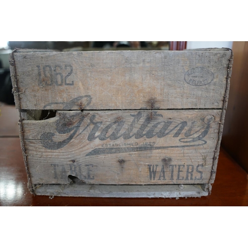 829 - A vintage Grattans wooden bottle crate and a vintage Lucozade glass bottle.