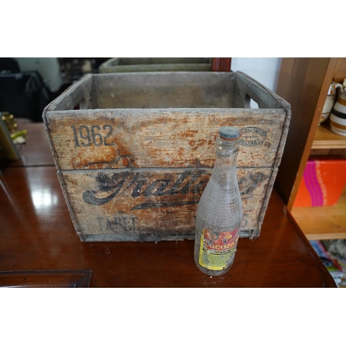 829 - A vintage Grattans wooden bottle crate and a vintage Lucozade glass bottle.