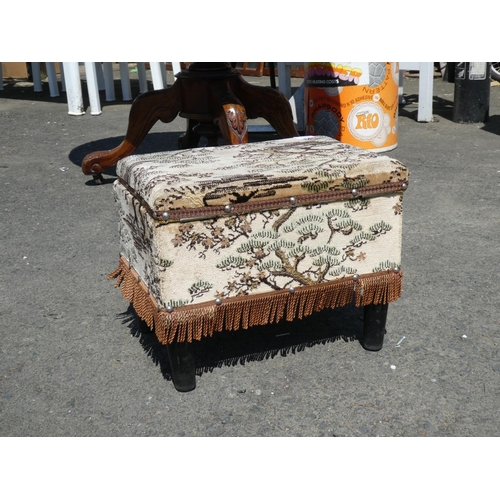 1025 - A small upholstered lidded footstool.