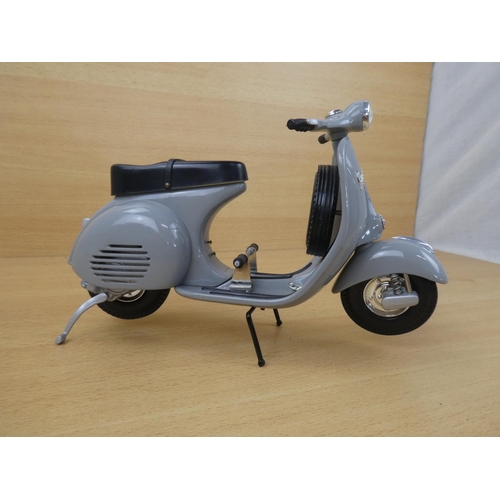 11 - A limited edition diecast Grey Vespa scooter, 1707/5000.