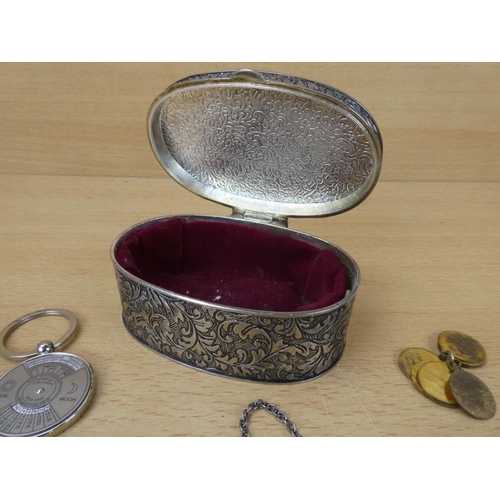 32 - A white metal trinket box and contents to include a Whiskey decanter label and more.