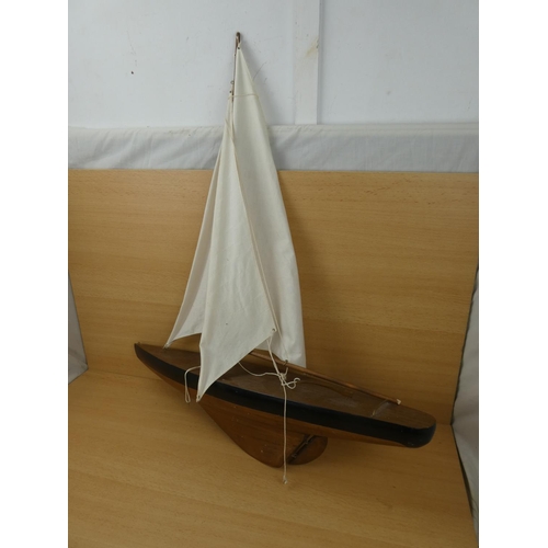 51 - A large model yacht with sail, measuring 70cm in length.