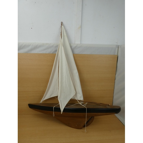 51 - A large model yacht with sail, measuring 70cm in length.