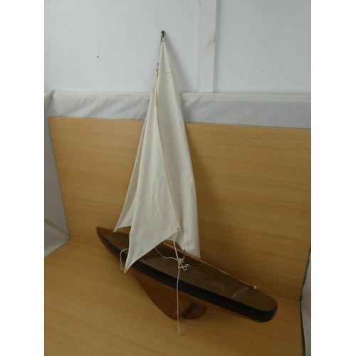 51 - A large model yacht with sail, measuring 70cm in length.