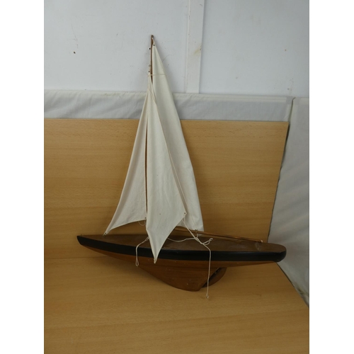 51 - A large model yacht with sail, measuring 70cm in length.