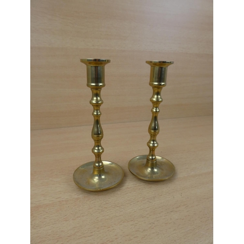 61 - A small pair of brass candlesticks.