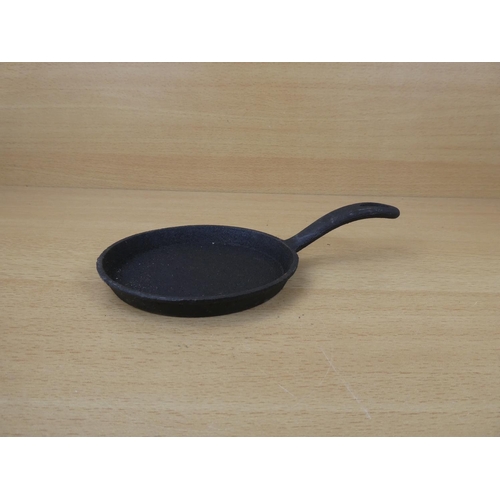 67 - A miniature cast iron skillet.