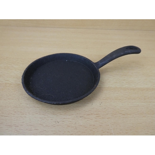 67 - A miniature cast iron skillet.