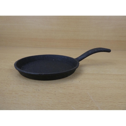 67 - A miniature cast iron skillet.