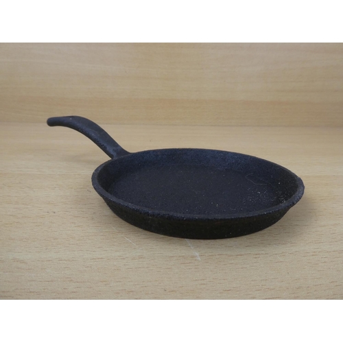 67 - A miniature cast iron skillet.