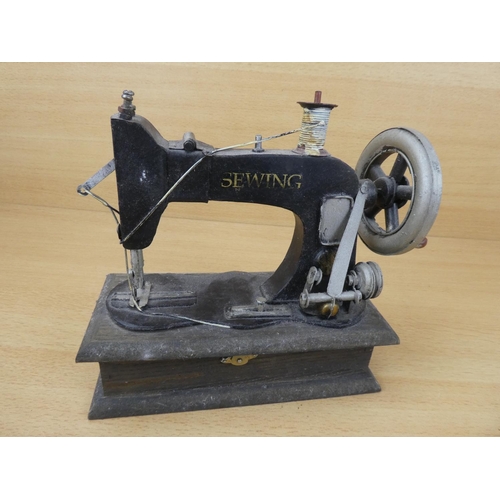 69 - A miniature sewing machine.